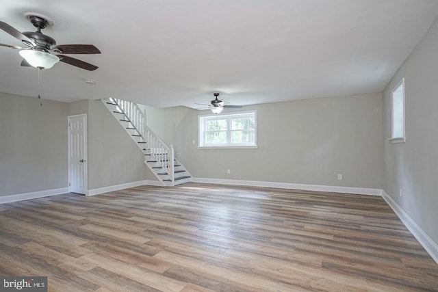 unfurnished living room with hardwood / wood-style flooring and ceiling fan