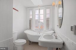 bathroom with tile patterned flooring, sink, toilet, and a bathing tub