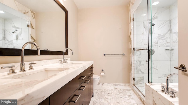 bathroom featuring marble finish floor, a sink, a marble finish shower, and toilet