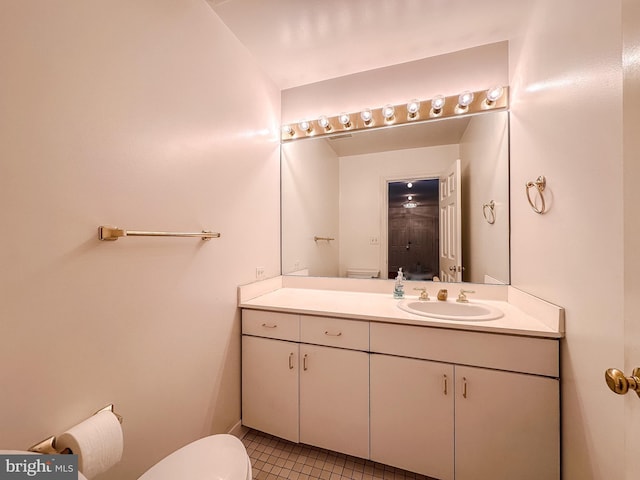 bathroom with vanity, tile patterned floors, and toilet