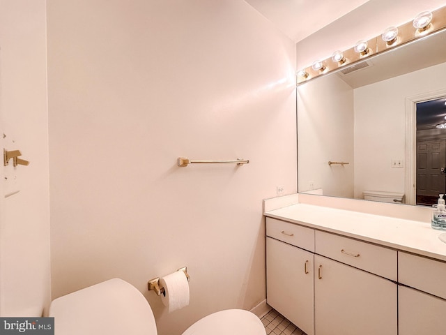 bathroom with vanity, tile patterned floors, and toilet