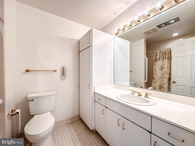 bathroom featuring vanity, toilet, curtained shower, and tile patterned flooring