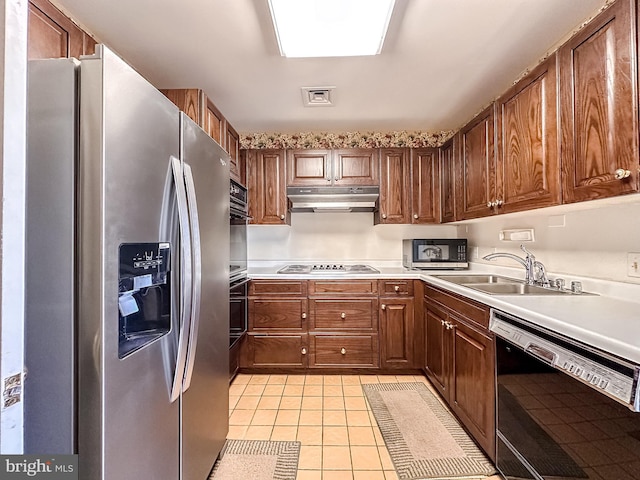 kitchen with stainless steel appliances, sink, and light tile patterned floors