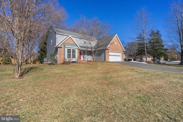 traditional-style home featuring driveway, brick siding, an attached garage, and a front yard