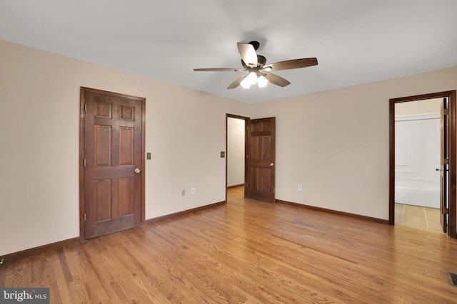 unfurnished bedroom with light wood-style flooring and baseboards