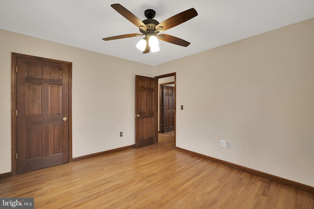 unfurnished bedroom featuring baseboards, ceiling fan, and light wood-style floors