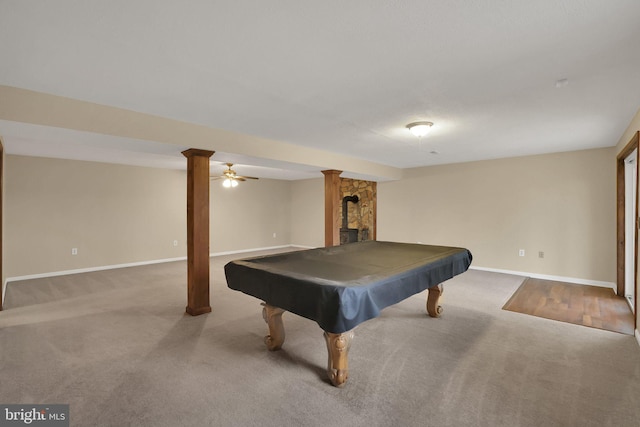 game room featuring a wood stove, billiards, baseboards, and light colored carpet