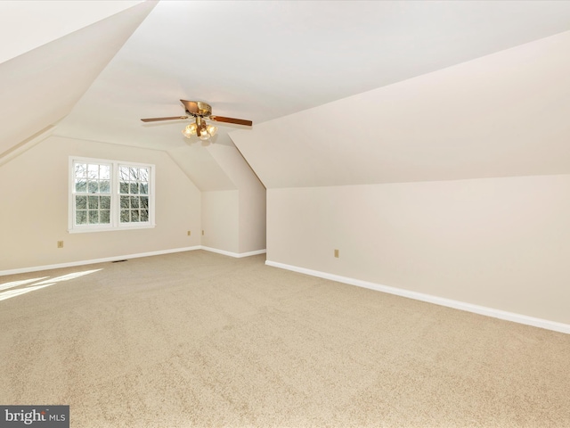 bonus room with carpet floors, lofted ceiling, ceiling fan, and baseboards