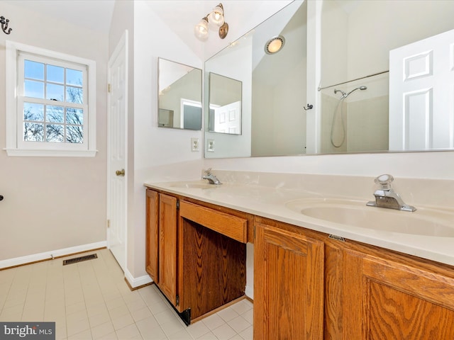 full bathroom featuring double vanity, a shower, a sink, and visible vents