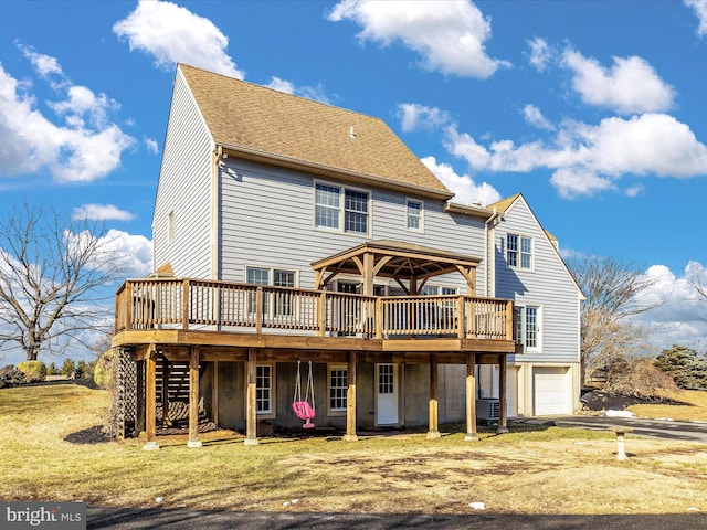 rear view of property with a shingled roof, an attached garage, stairs, cooling unit, and a wooden deck