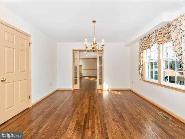 unfurnished dining area with baseboards, visible vents, and dark wood-style flooring