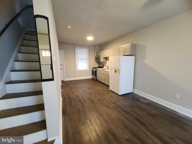 kitchen featuring stainless steel appliances, dark hardwood / wood-style floors, and white cabinets