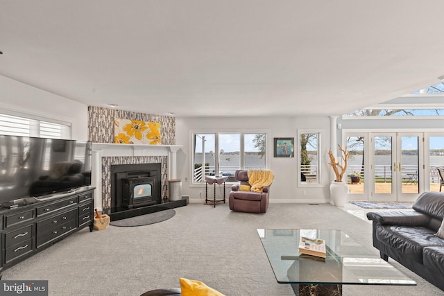 317 Kennard Ave, Edgewood, MD 21040 - living room featuring carpet, french doors, baseboards, and a warm lit fireplace