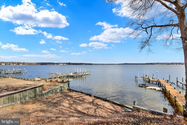 dock area with a water view and boat lift