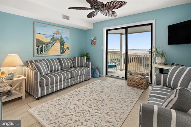 living area with ceiling fan and visible vents