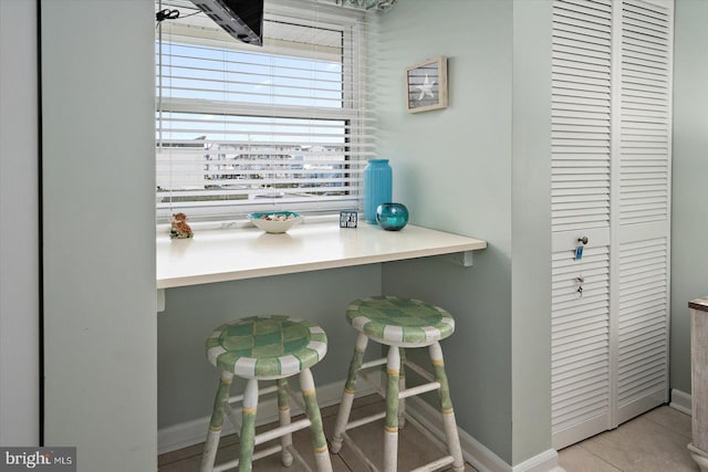 kitchen featuring light tile patterned floors, baseboards, and light countertops