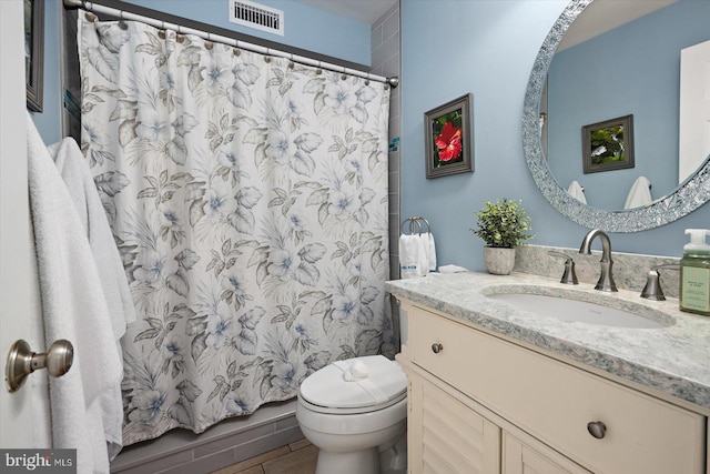 bathroom featuring curtained shower, visible vents, toilet, vanity, and wood finished floors