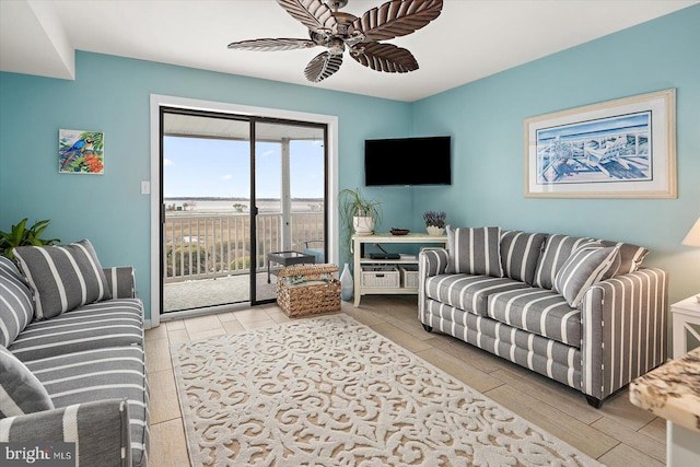 living room featuring a ceiling fan and wood tiled floor