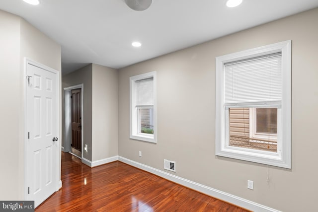 spare room featuring dark hardwood / wood-style floors