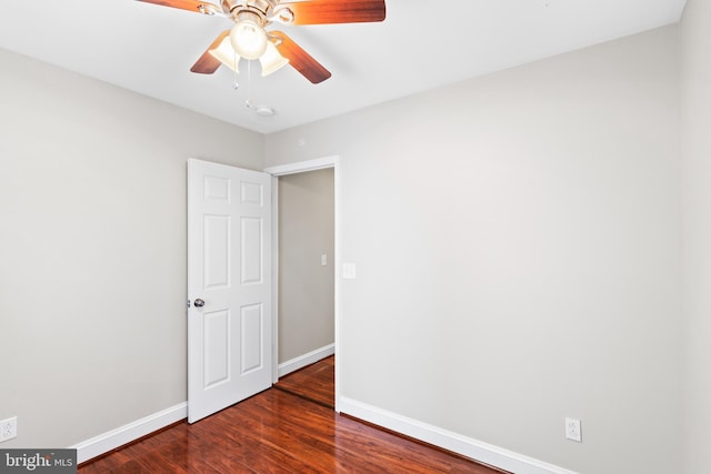 unfurnished bedroom featuring dark wood-type flooring and ceiling fan