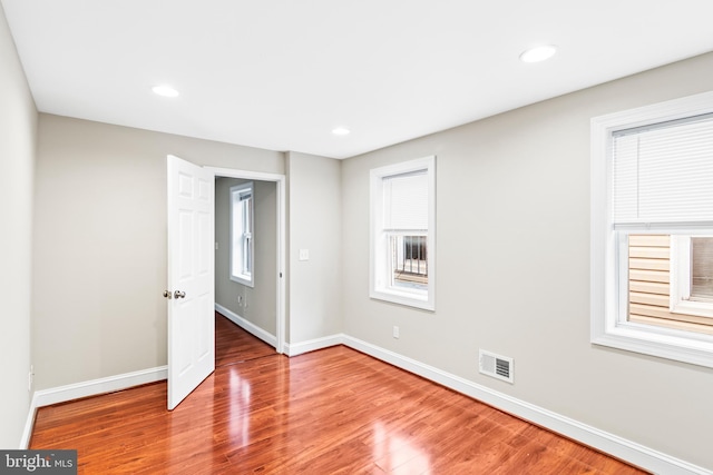 unfurnished room with wood-type flooring