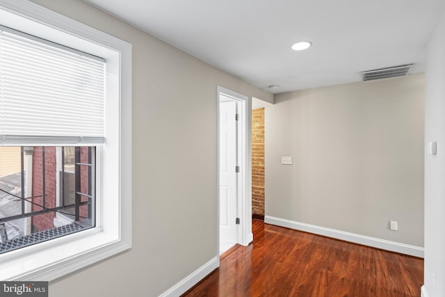 empty room featuring dark hardwood / wood-style flooring