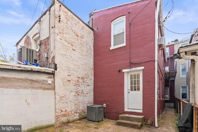 back of property featuring central AC