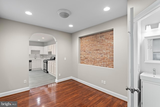 interior space with sink and dark wood-type flooring