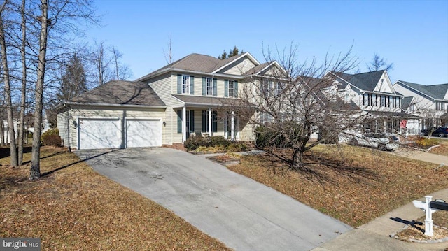 view of front of property with a porch, driveway, and an attached garage