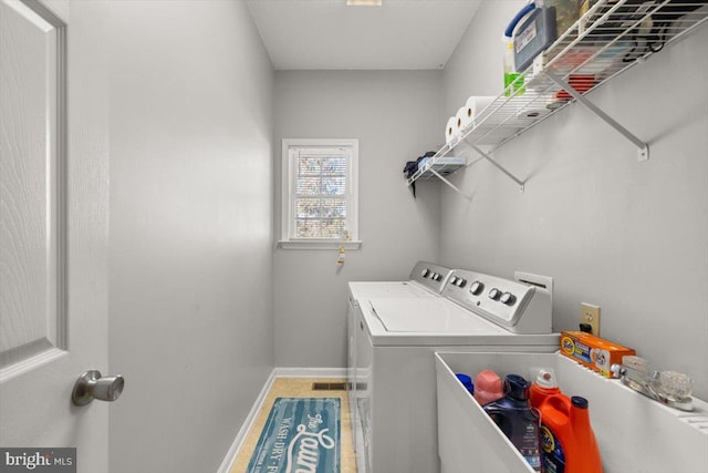 laundry room with washer and dryer, laundry area, and baseboards