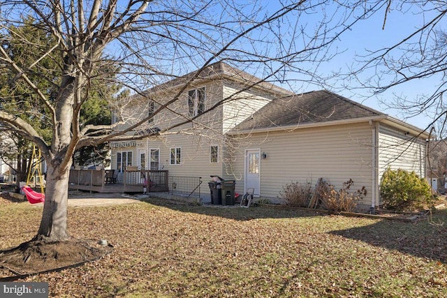 view of property exterior featuring a deck and roof with shingles