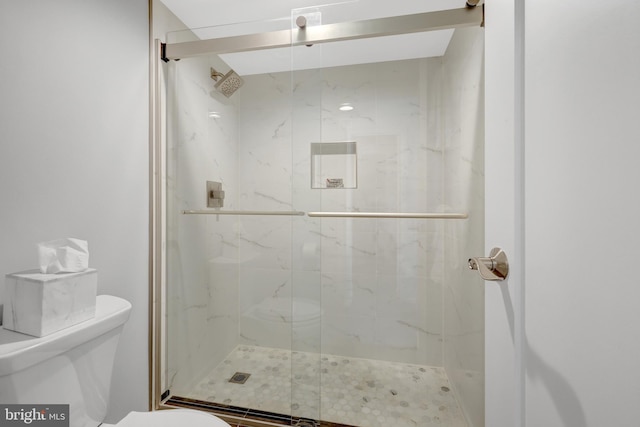 bathroom with an enclosed shower and toilet