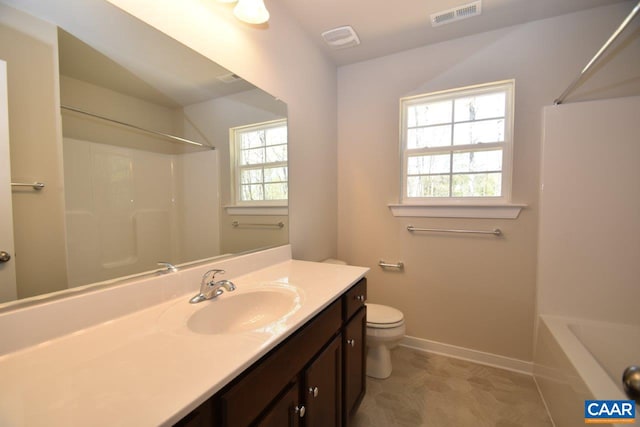 bathroom with vanity, plenty of natural light, and toilet