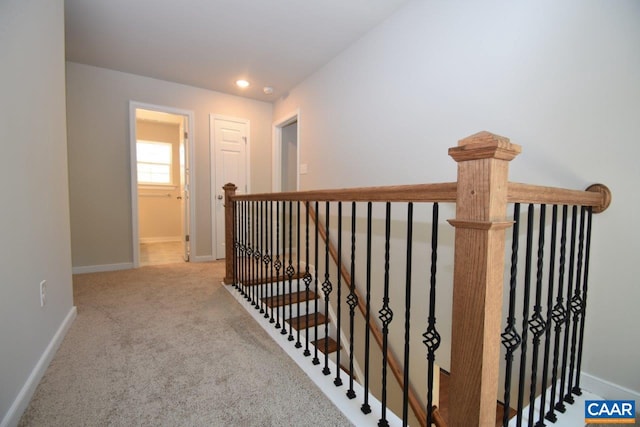 hallway featuring light carpet