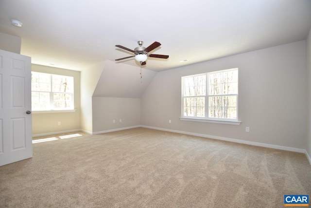 bonus room with ceiling fan, lofted ceiling, and light carpet