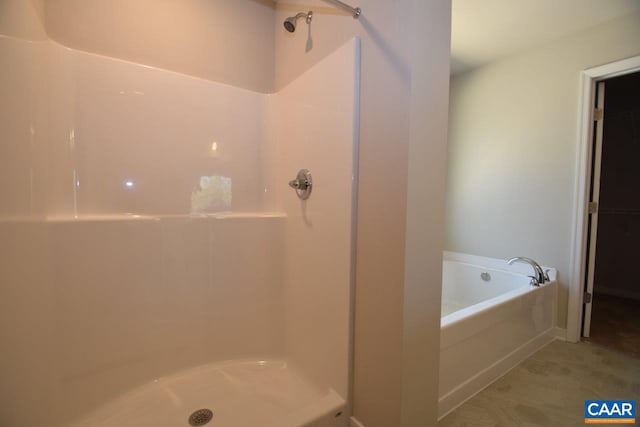 bathroom featuring separate shower and tub