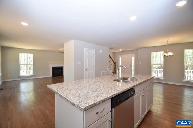 kitchen with sink, dishwasher, pendant lighting, a kitchen island with sink, and white cabinets