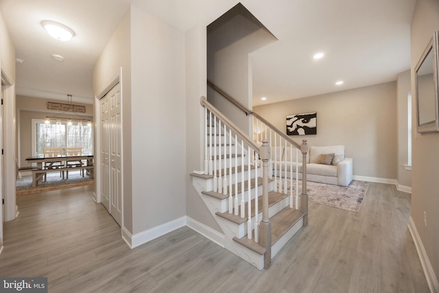 stairway with hardwood / wood-style flooring