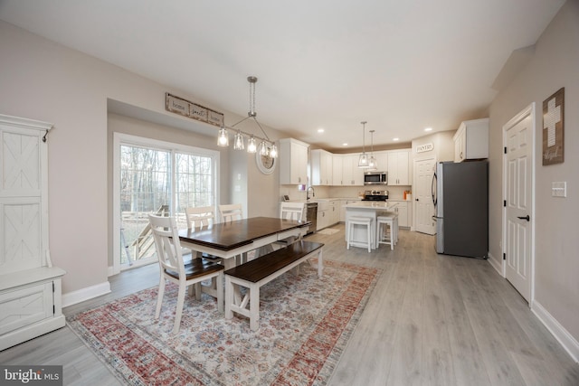 dining space with light wood-type flooring