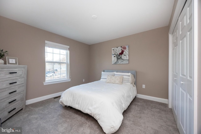 bedroom featuring a closet and light carpet