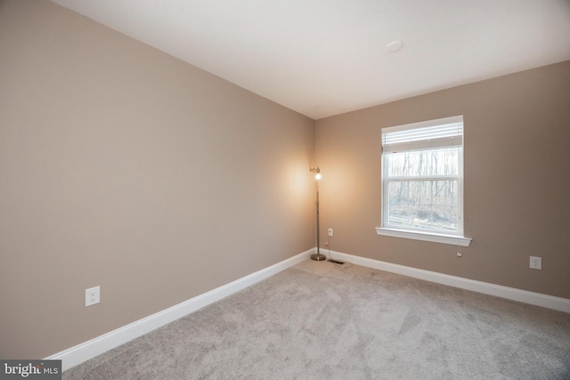 unfurnished room featuring light colored carpet