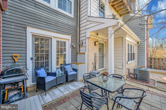 wooden terrace featuring central AC unit, a patio, grilling area, fence, and outdoor lounge area