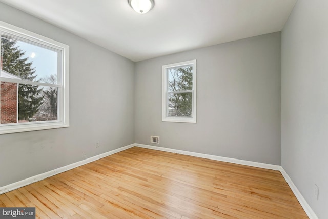 spare room featuring light hardwood / wood-style flooring