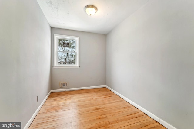 empty room with light hardwood / wood-style floors