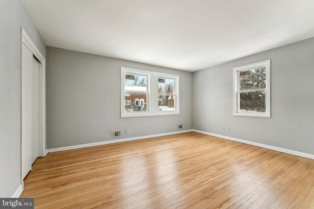 unfurnished bedroom featuring a closet and light hardwood / wood-style flooring