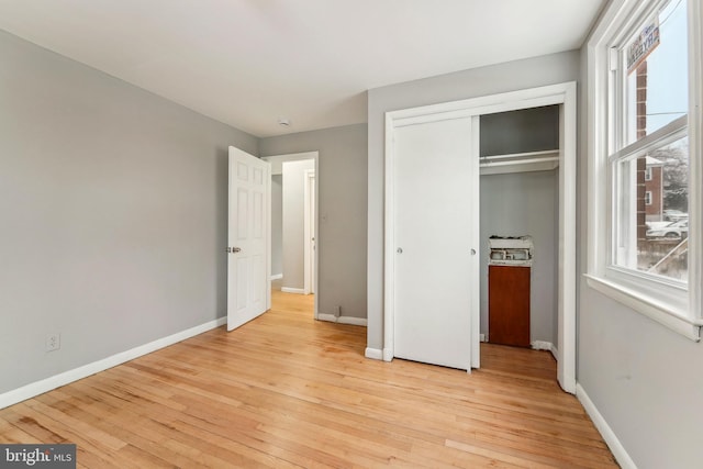 unfurnished bedroom featuring a closet and light hardwood / wood-style flooring