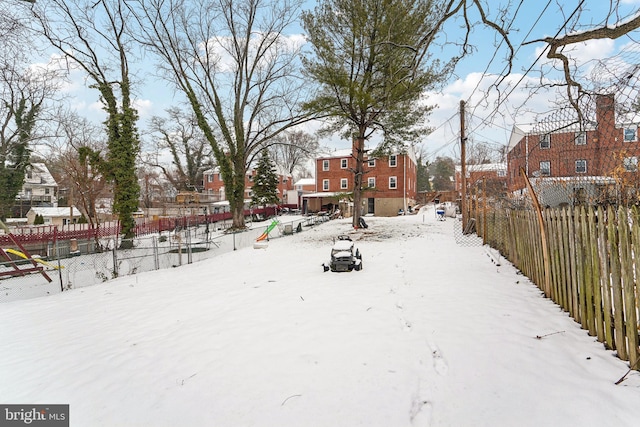 view of yard layered in snow