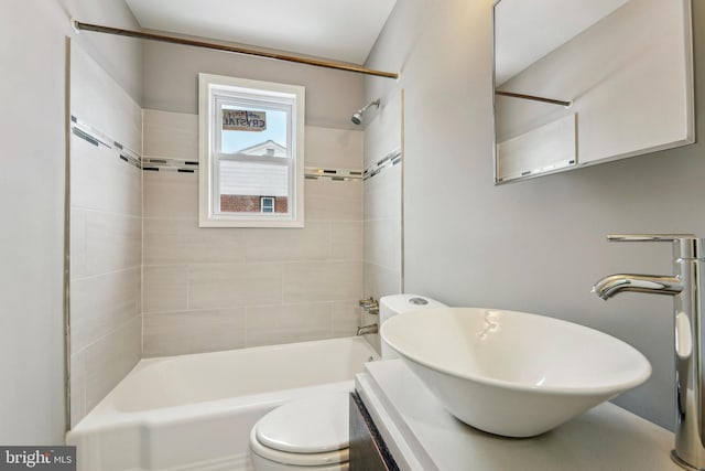 full bathroom featuring vanity, toilet, and tiled shower / bath combo