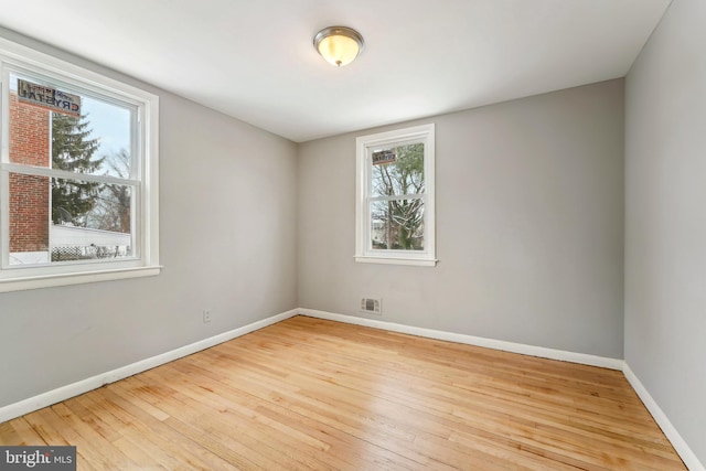 spare room featuring light hardwood / wood-style flooring