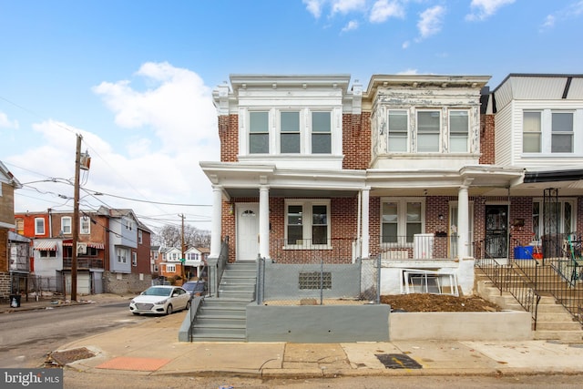 townhome / multi-family property featuring a porch